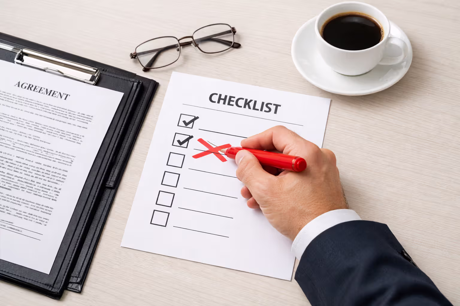 Hand holding magnifying glass over medical document examining evidence of negligence