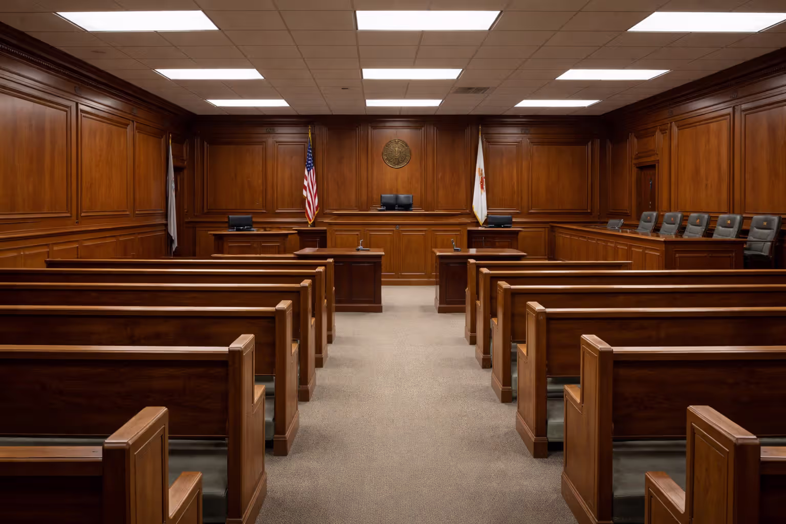 Empty American courtroom interior with wooden benches judge bench jury box and flag